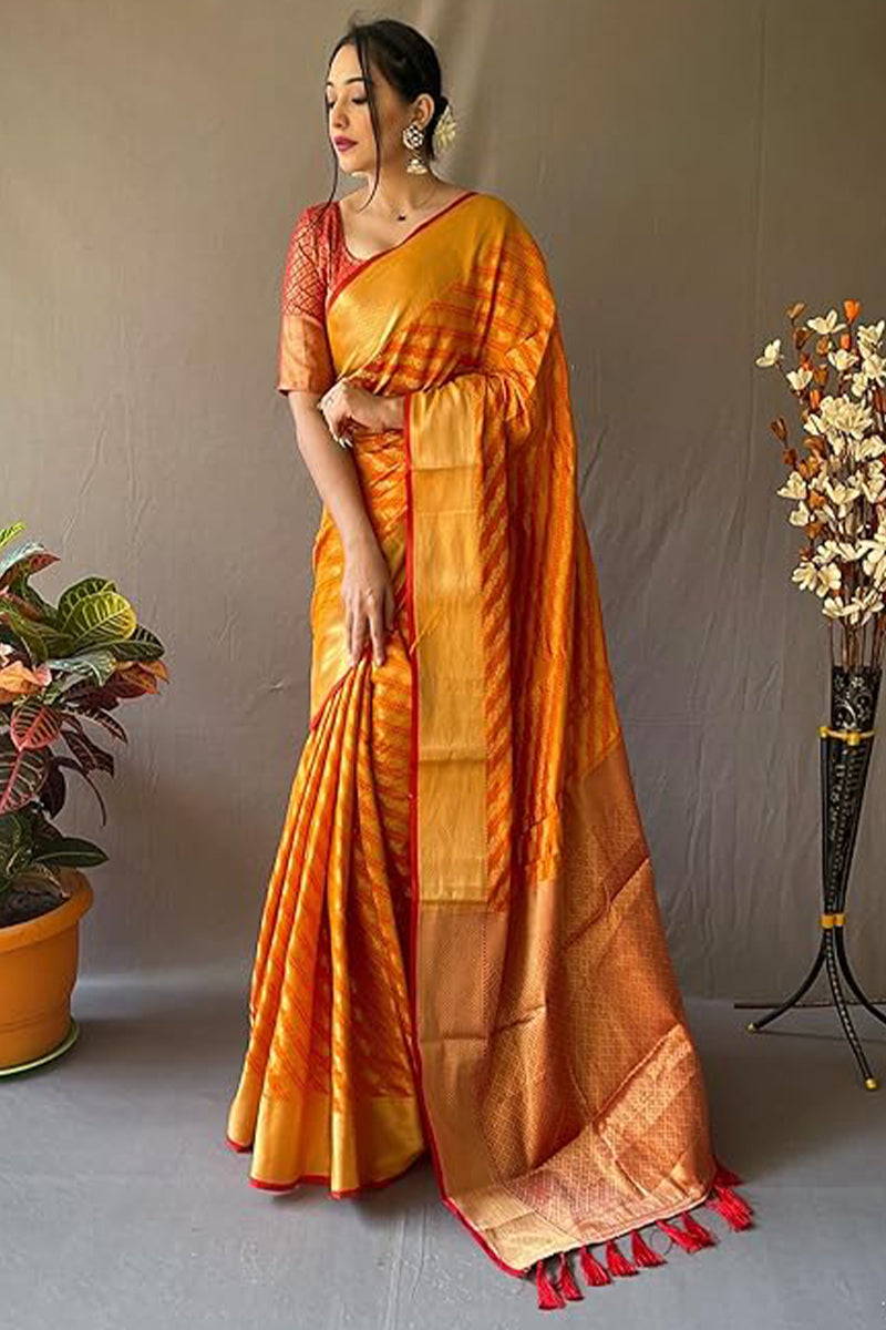 Cynosure Mustard Soft Banarasi Silk Saree With Prettiest Blouse Piece