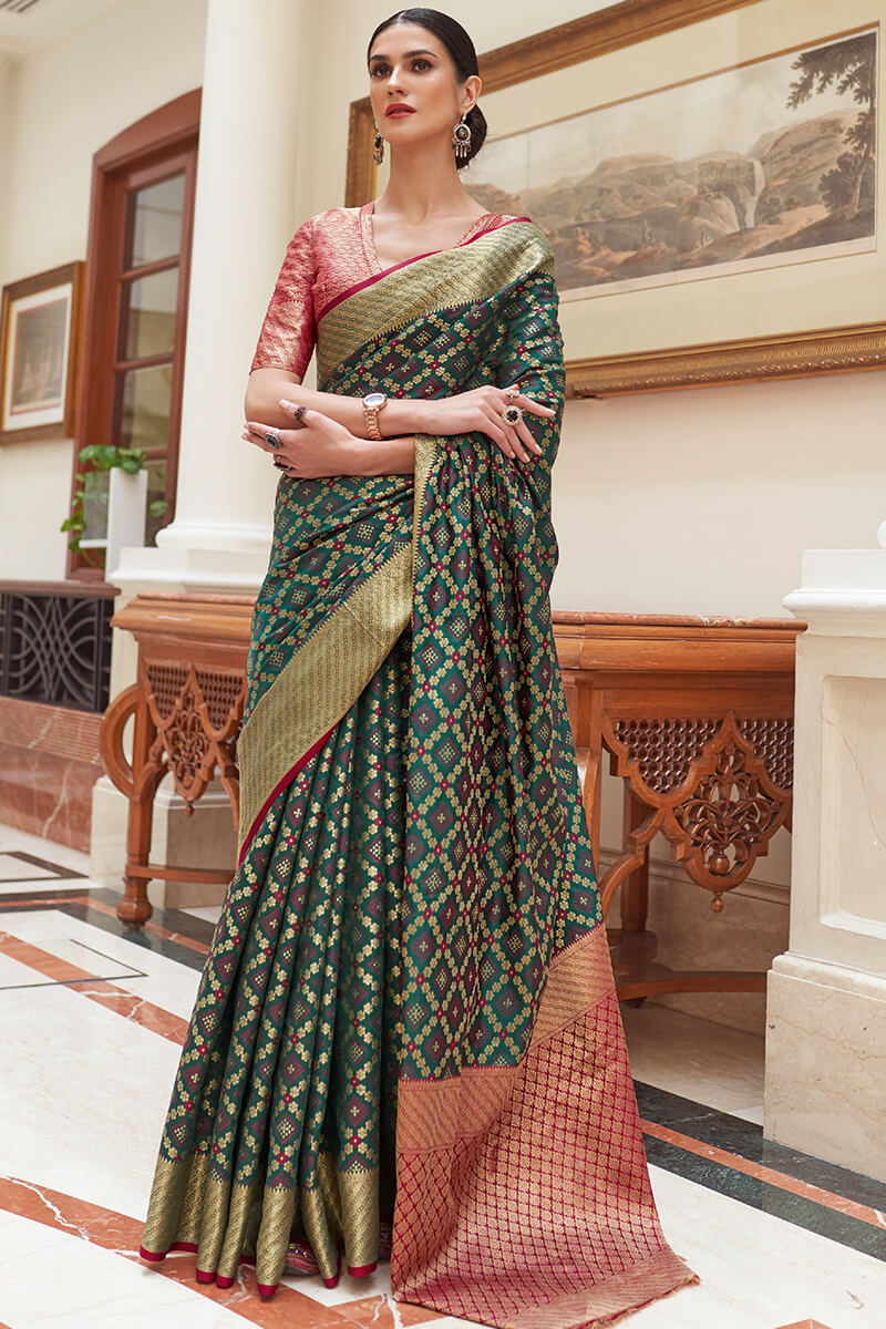 Cynosure Dark Green Soft Patola Silk Saree with Ethereal Blouse Piece