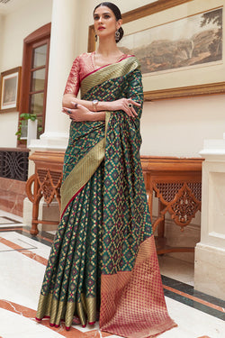 Cynosure Dark Green Soft Patola Silk Saree with Ethereal Blouse Piece