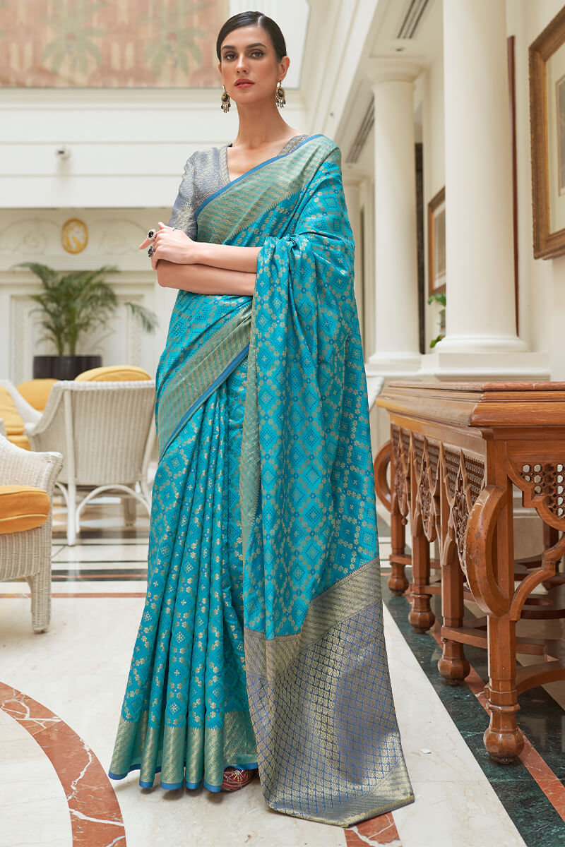 Mellifluous Firozi Soft Patola Silk Saree with Tantalizing Blouse Piece