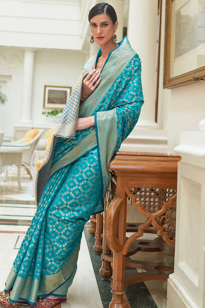 Mellifluous Firozi Soft Patola Silk Saree with Tantalizing Blouse Piece