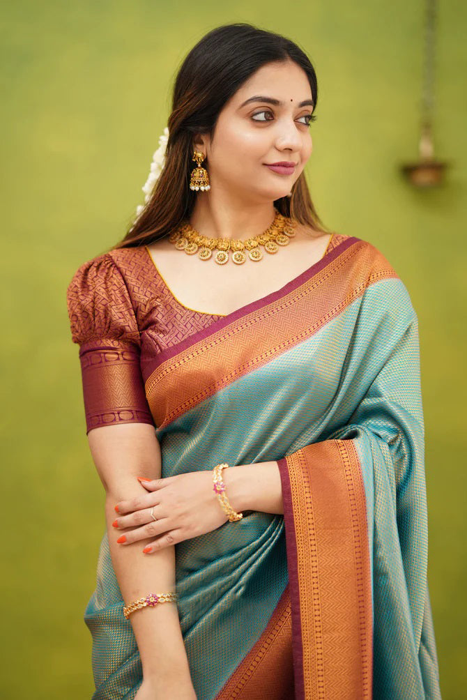 Embrocation Firozi Soft Banarasi Silk Saree With Ephemeral Blouse Piece